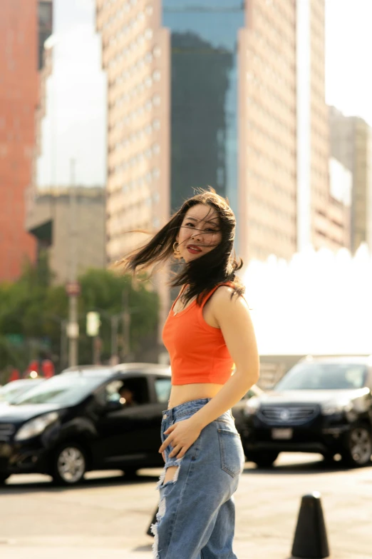 a girl in high waist jeans posing on the street