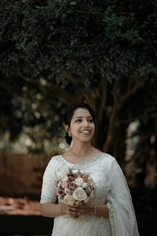 the bride in the white dress holding her wedding bouquet