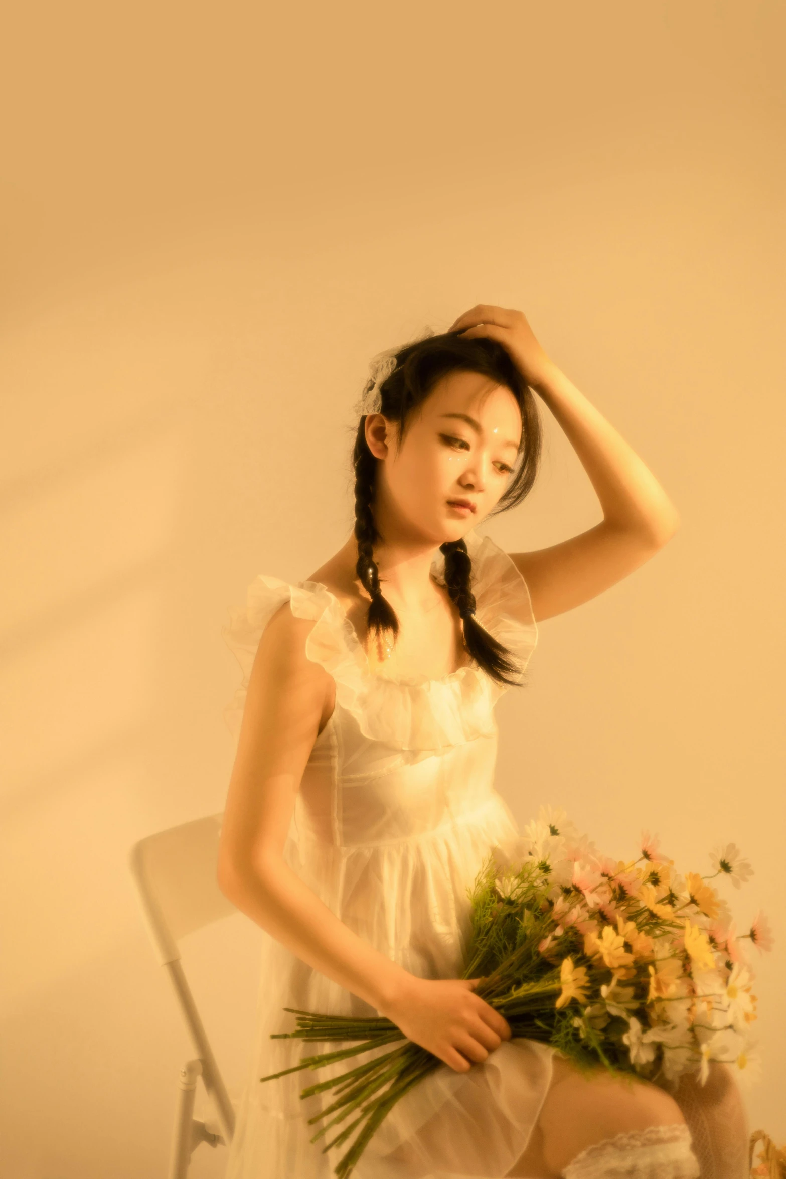 a beautiful woman sitting next to a flower bouquet