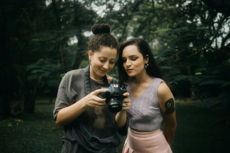 two people are standing outside taking pictures