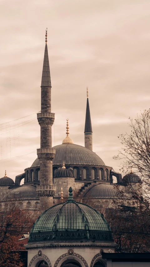 a gray stone building with a green dome