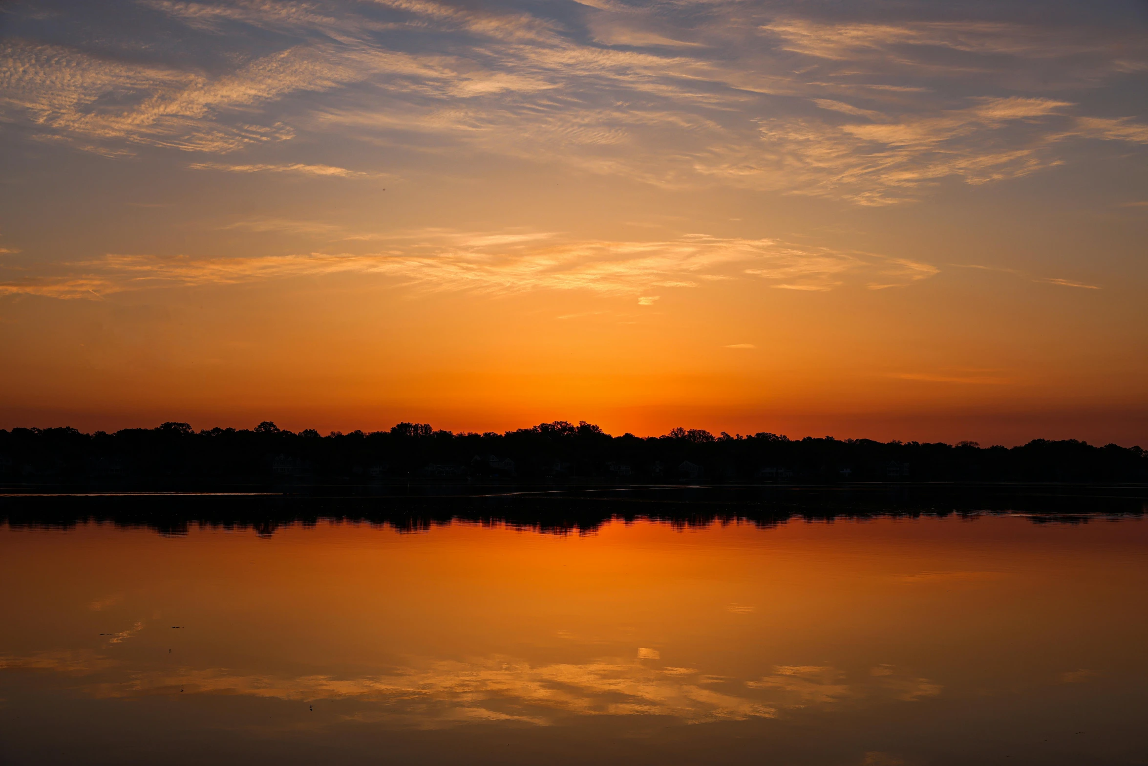 the sky is reflected in the still water