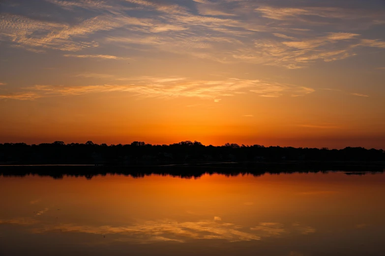 the sky is reflected in the still water