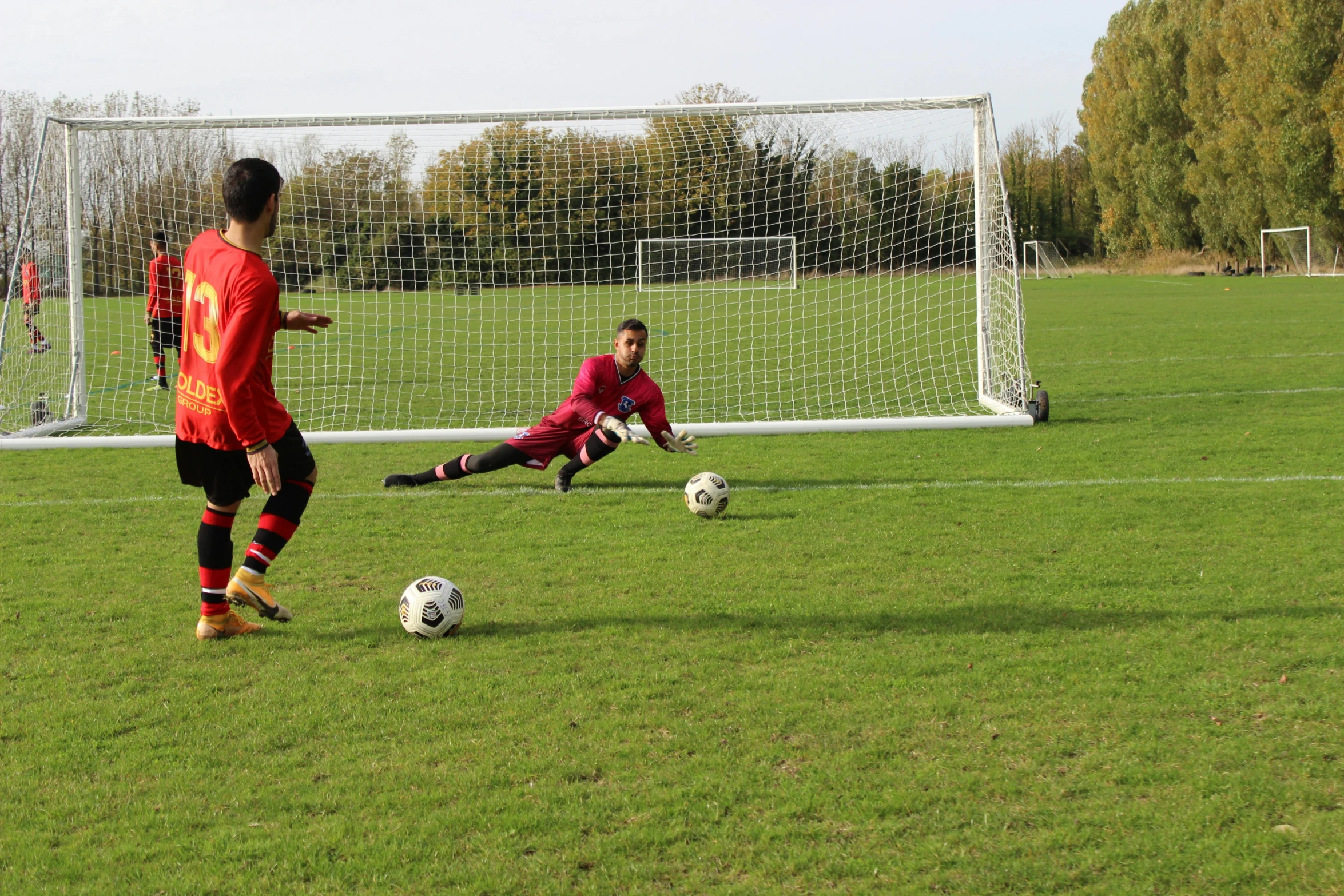 two soccer players in the field, one with the ball