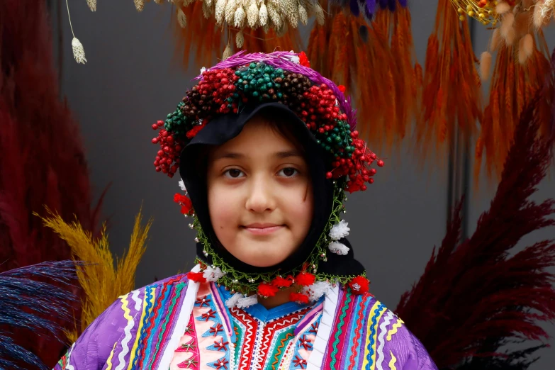 the young child is wearing a colorful outfit