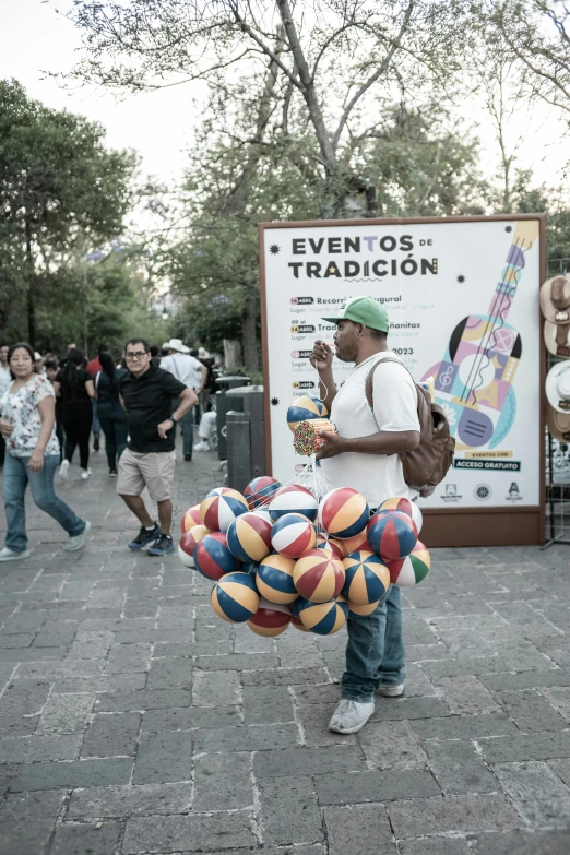 a person on a street holding a group of balloons