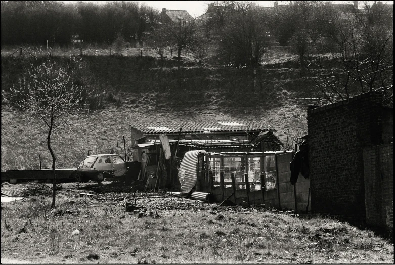 an old truck in front of a building with no roof