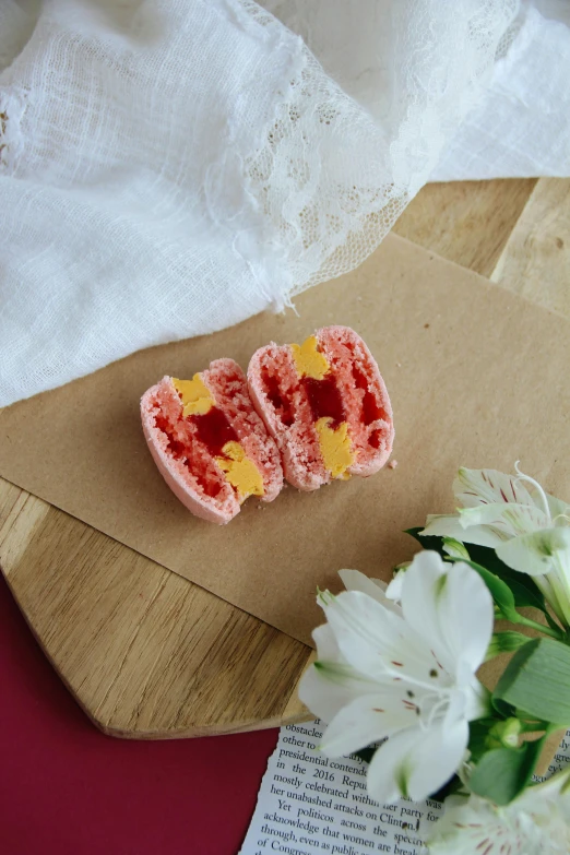 a small cupcake made to look like a heart with yellow and red hearts