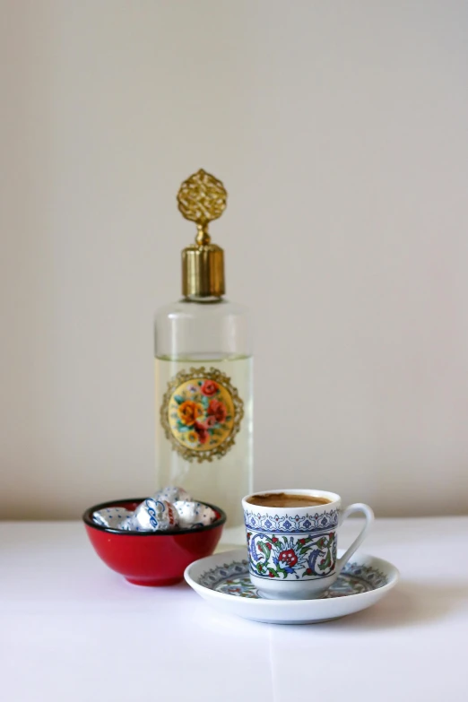 a bottle and bowl sitting on top of a table