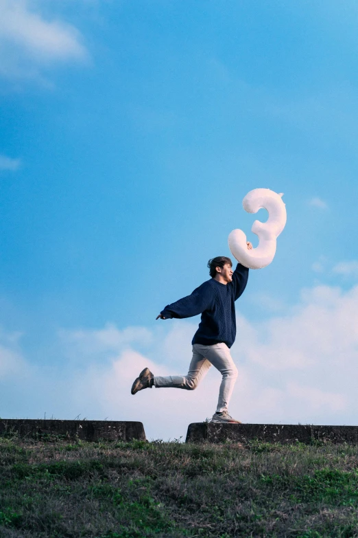 a man wearing white pants and holding a white frisbee