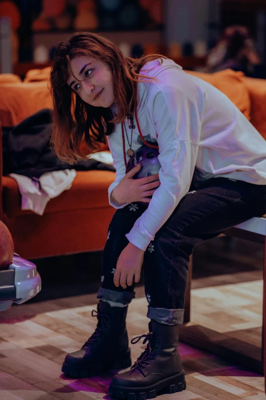 girl in jeans and a shirt looking down at her shoes