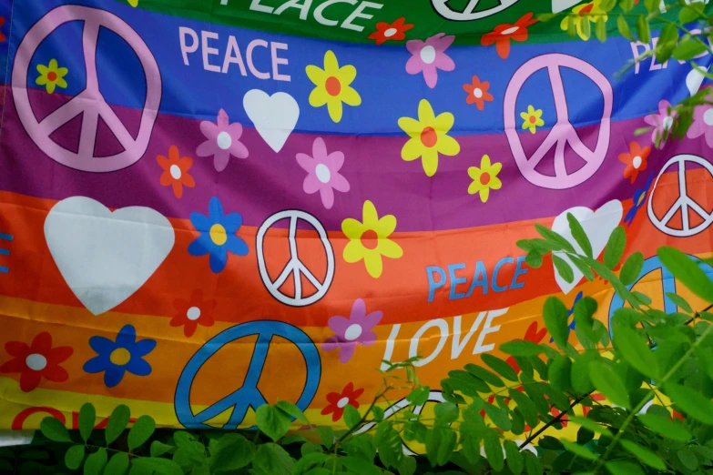 the colorful peace banner is hung outside of a building