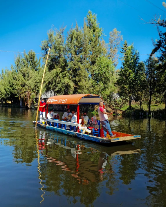 a small passenger boat on the water with tourists