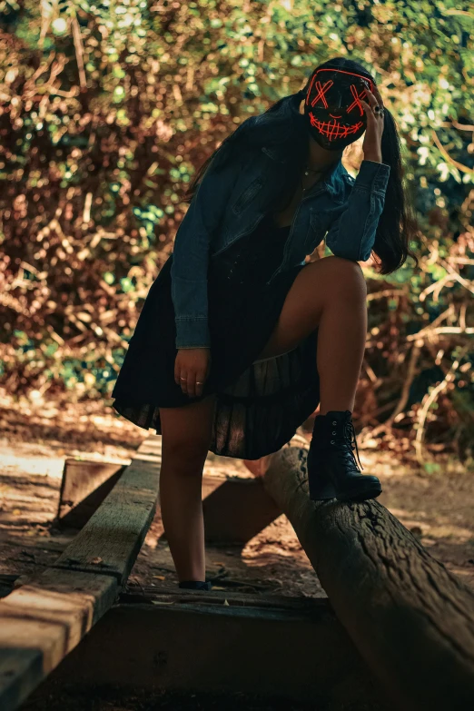 a person sitting on a piece of wood wearing a helmet