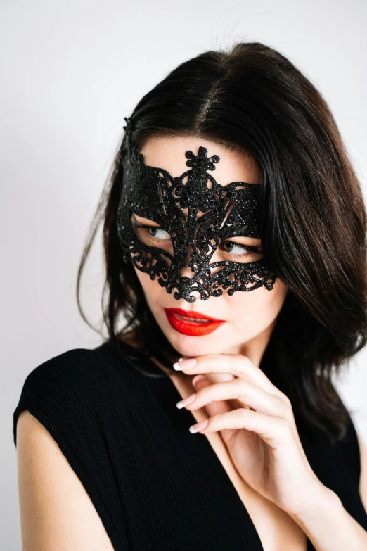 a woman in black lace mask on her face