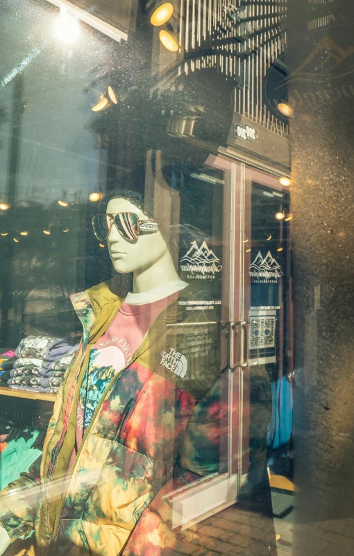 the mannequin is standing in front of a clothing shop window