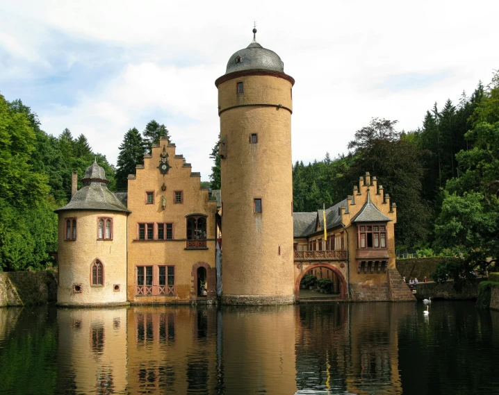 a castle like building is by a body of water