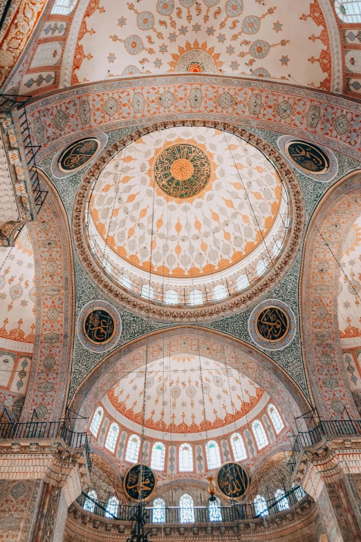 the ceiling of an ornate building with a stained glass window