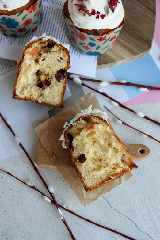 four frosted cake items on a table with chocolate sauce on top