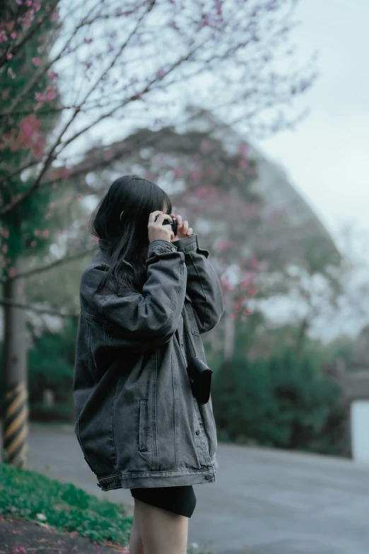 a person with a cellphone is walking on a street