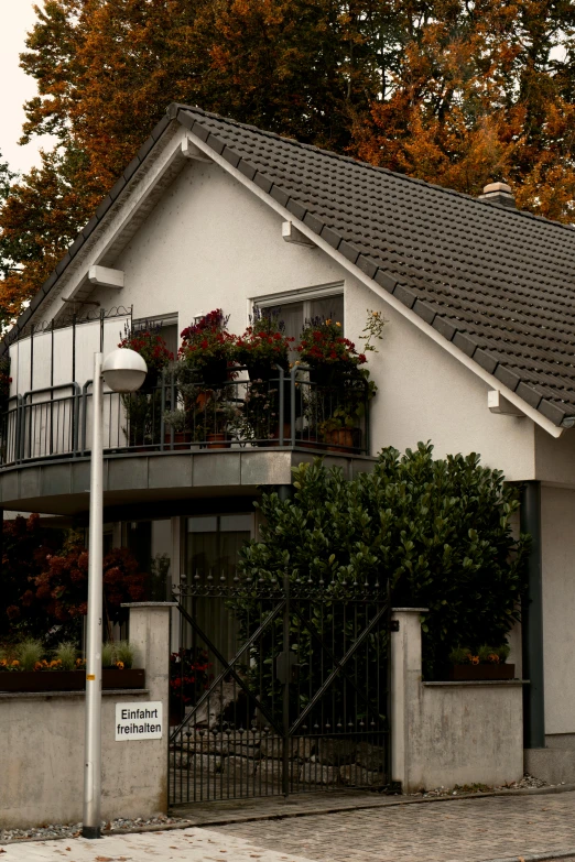 an elegant white house with flower boxes in front