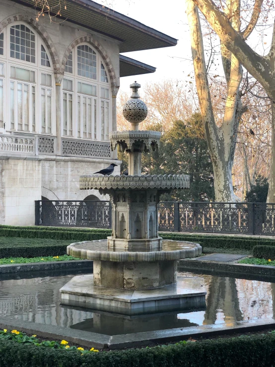 a building with an elaborate fountain in front of it