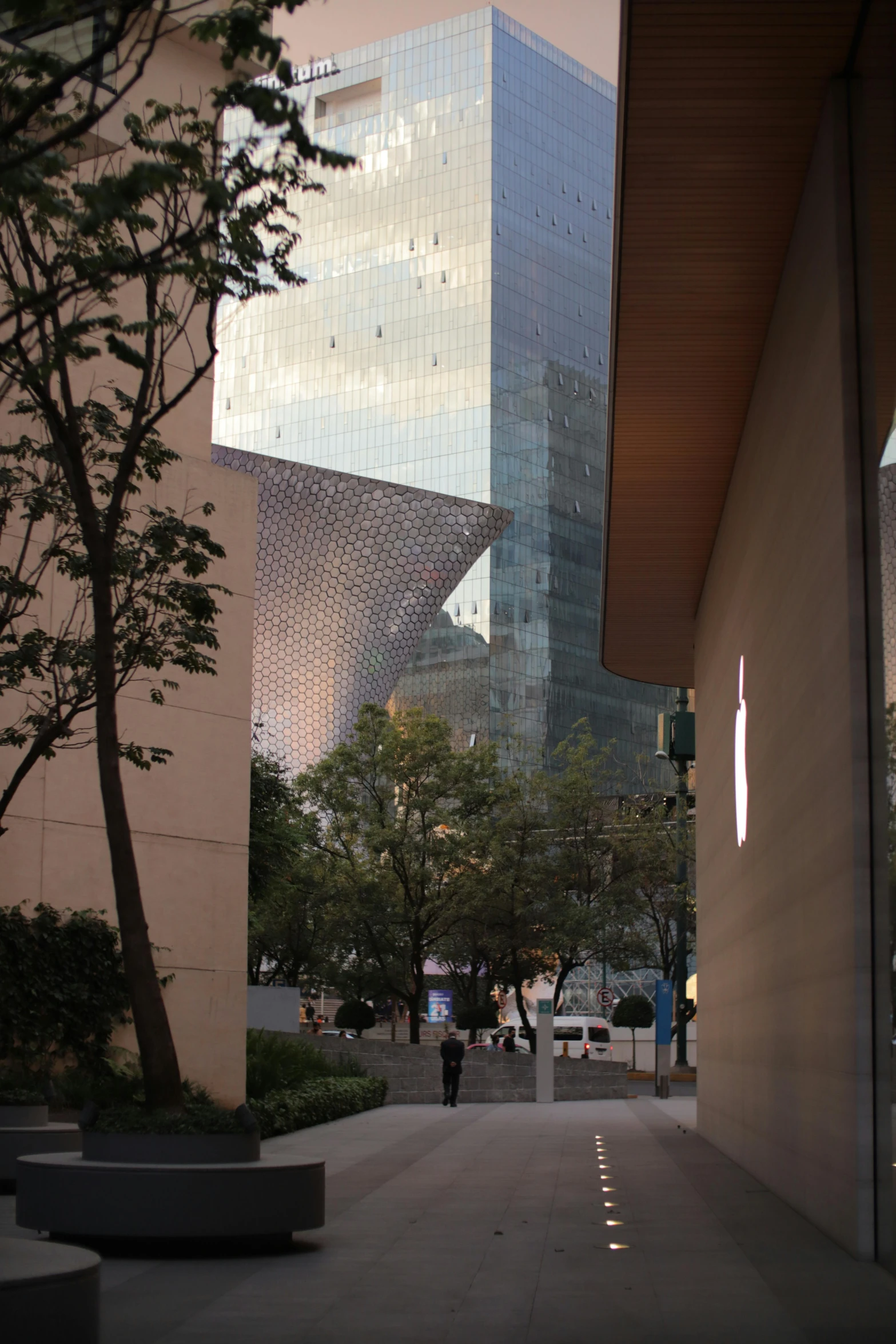 a large building sits in the background on a city street