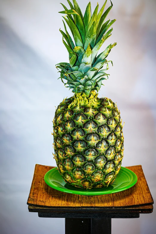 a small pineapple on a glass plate