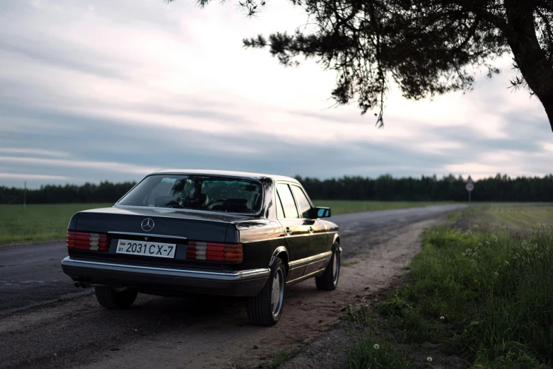 a car parked on a road in the middle of a country