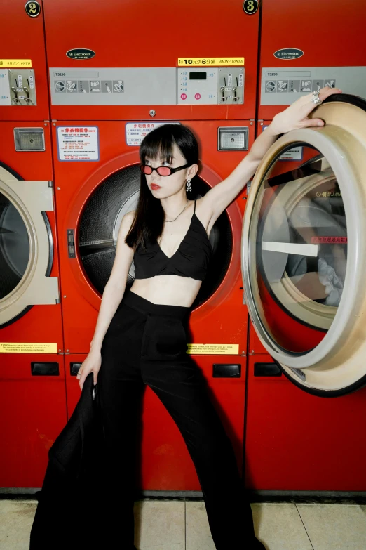 a woman in a crop top next to an orange dryer