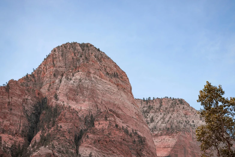 a mountain covered in rocks and a blue sky