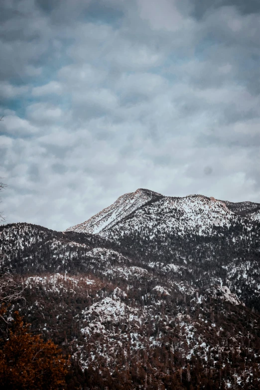 two distant mountains under cloudy skies on a gloomy day