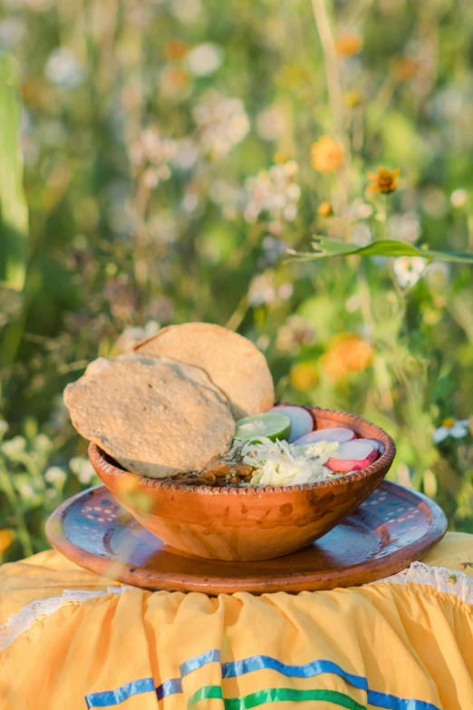 a plate with a bowl filled with food on top of it