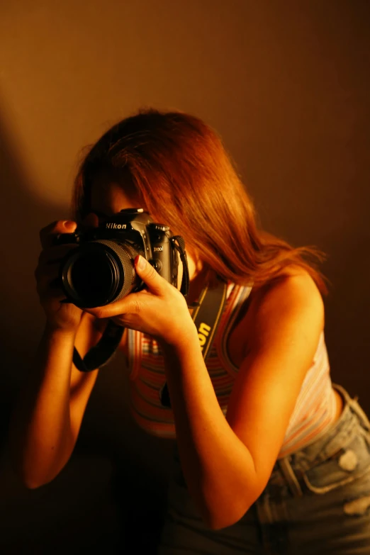 a woman is holding a camera to take a picture