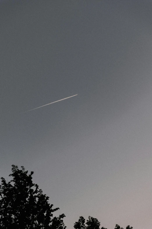the sky with a plane flying through it