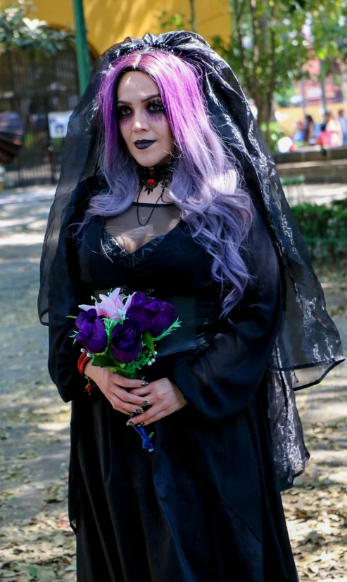 a woman wearing a witch costume is walking down the street