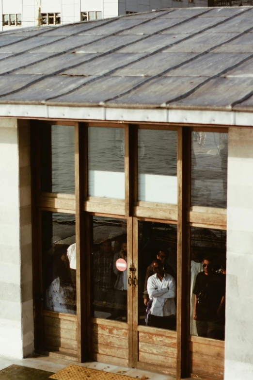 three open windows with a small wooden door