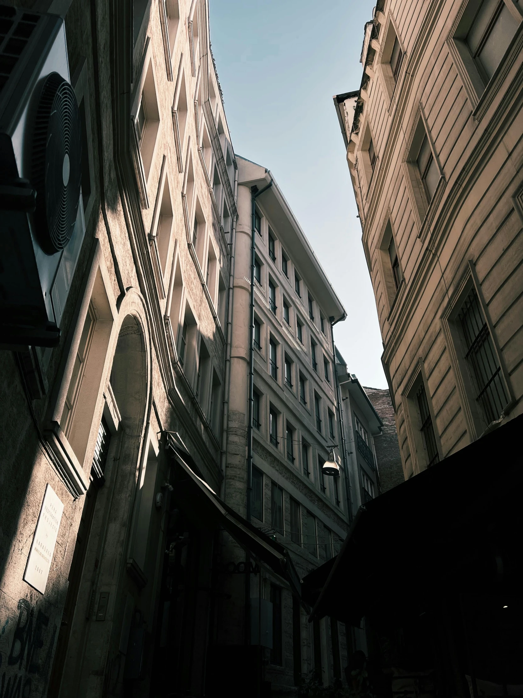 a narrow city street next to tall buildings