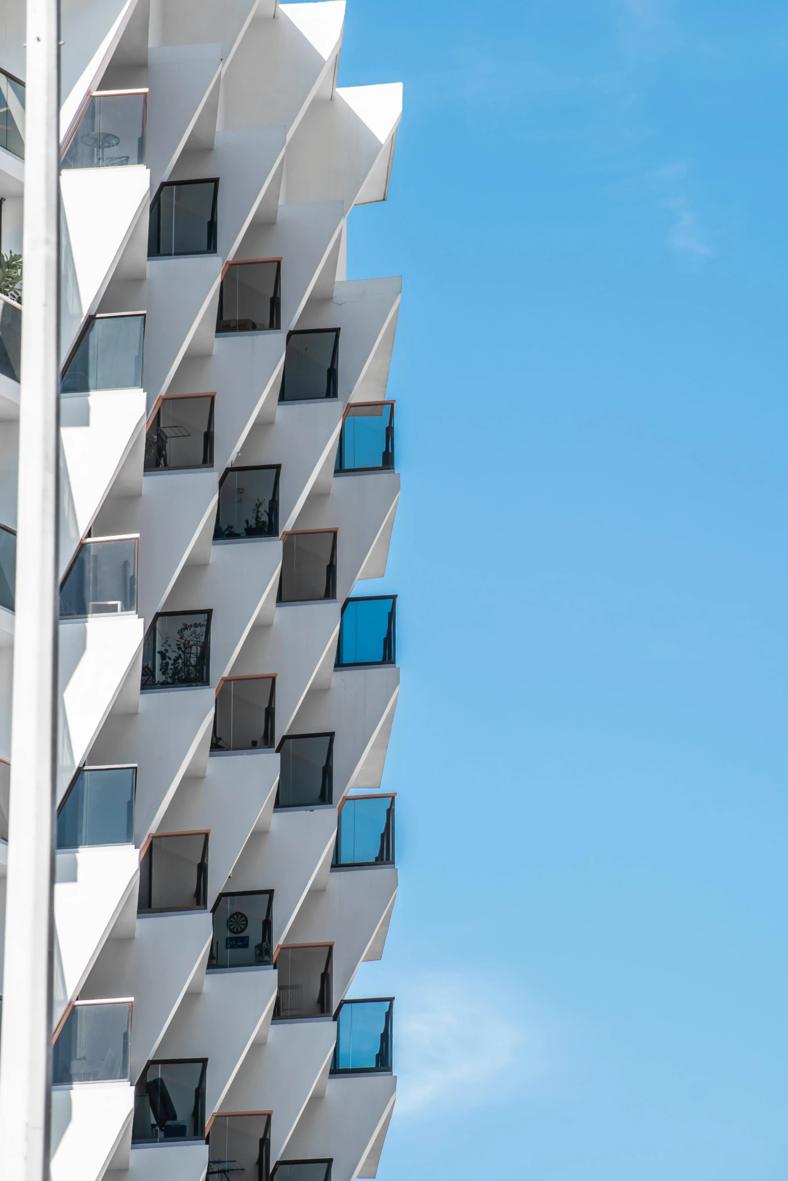 the side of an older building, with balconies at each window