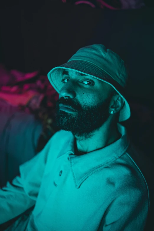 a man with a hat in a dark room