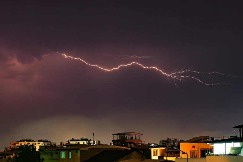 lightning lights up the sky in the background