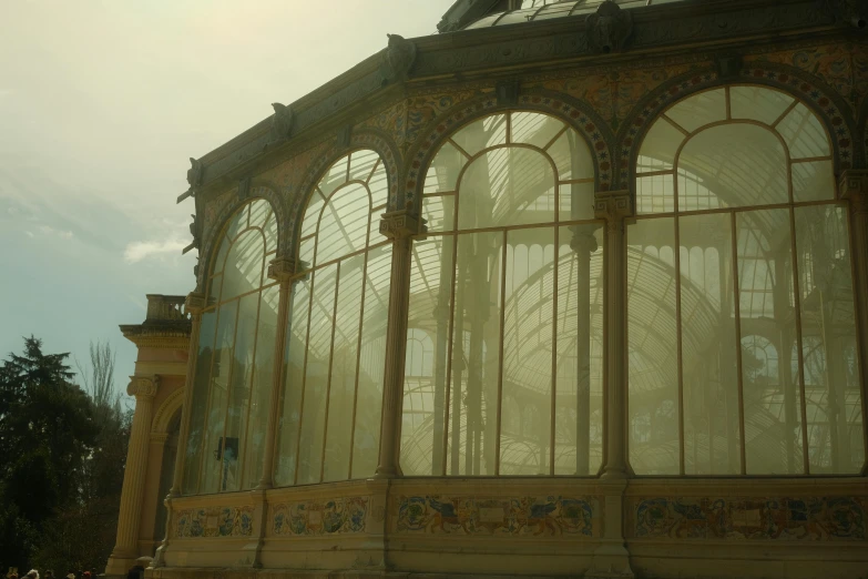 the outside of a building with ornately carved windows and wrought iron frameworks