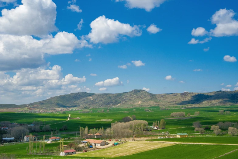 a countryside with hills and fields in the distance