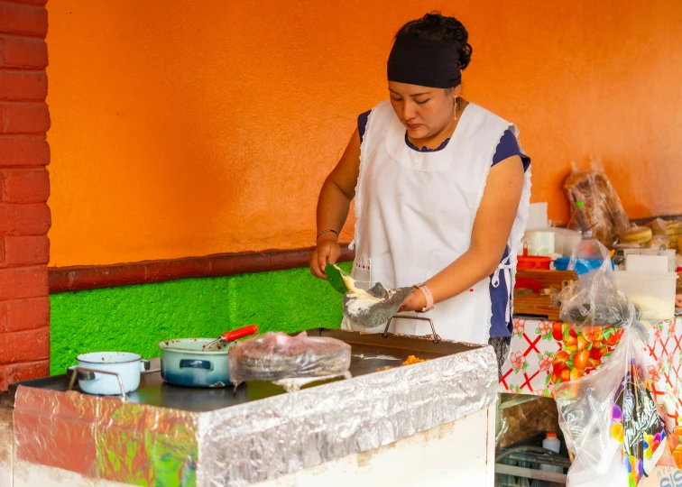 a woman standing over a tray filled with food