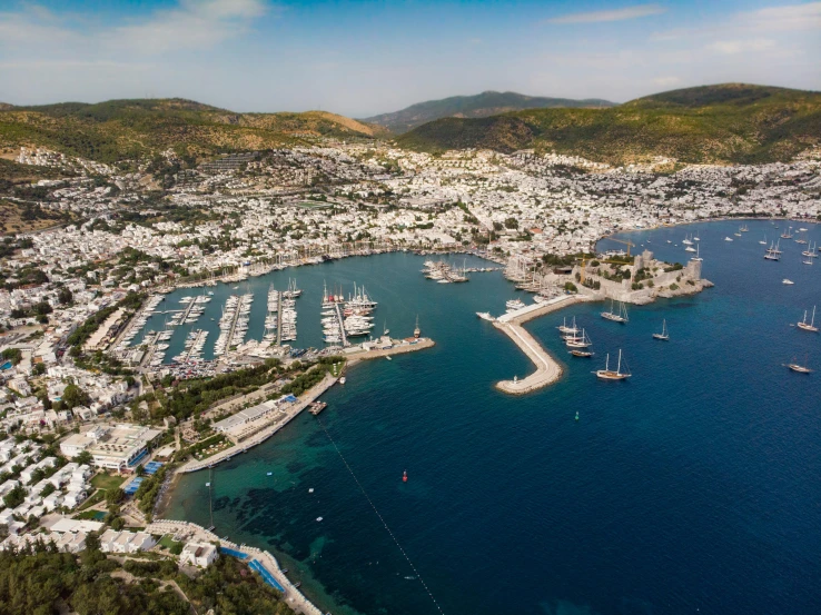 aerial view of a marina surrounded by mountains and houses