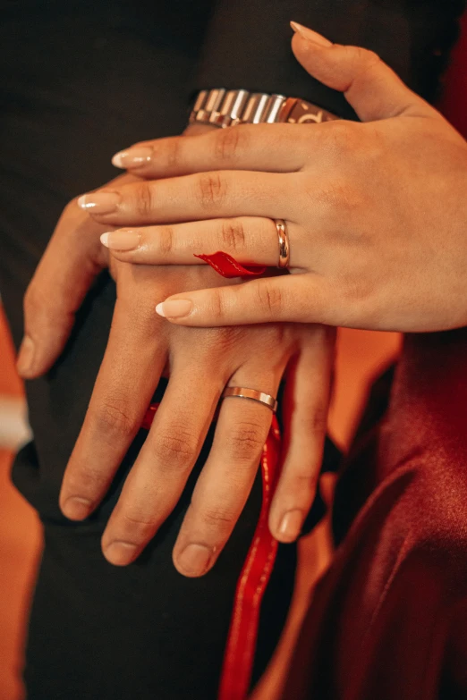 hands on a woman with two rings on their fingers
