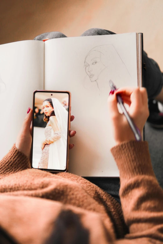 someone taking a po with their cell phone in front of a book