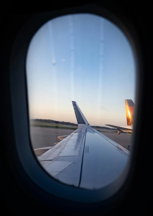 the wing of an airplane as seen through an airplane window