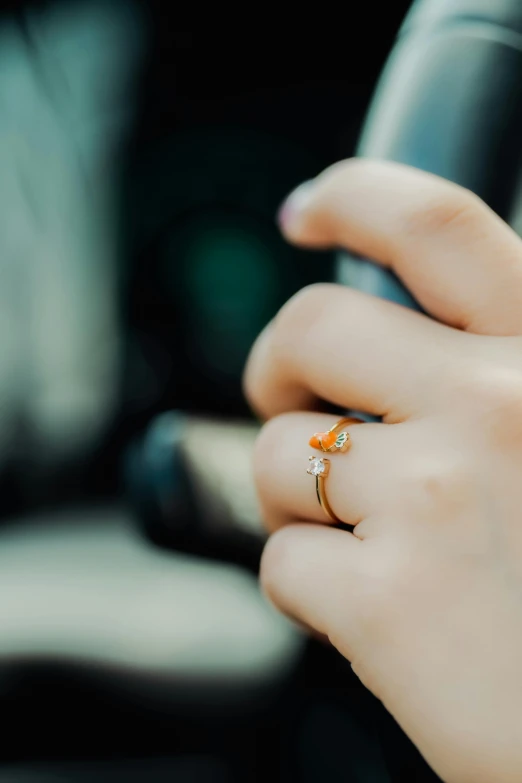 the woman is holding up a diamond and a cell phone