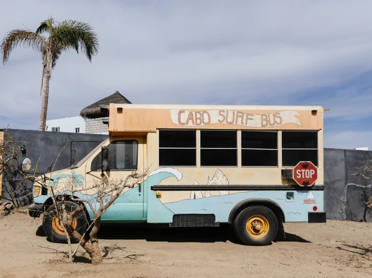 a dirty blue and yellow bus with some graffiti on it